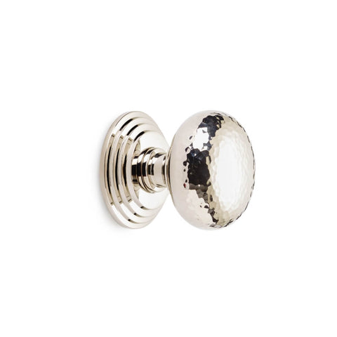Hammered polished nickel cottage centre door knob with stepped backplate, side profile on white background