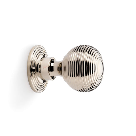 Side profile view of polished nickel reeded beehive rim mortice door knob with circular backplate.