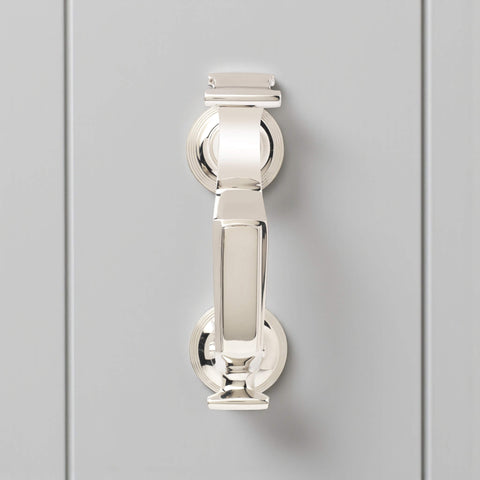 Front view of polished nickel reeded doctor door knocker on grey door, displaying traditional doctor style design and bright nickel finish.