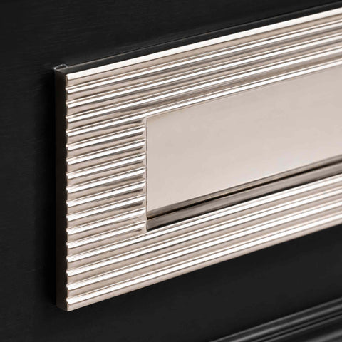Detailed corner view of polished nickel reeded frame and polished flap on solid brass letter box plate