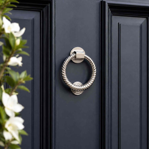 Polished nickel reeded ring door knocker installed on a dark blue front door