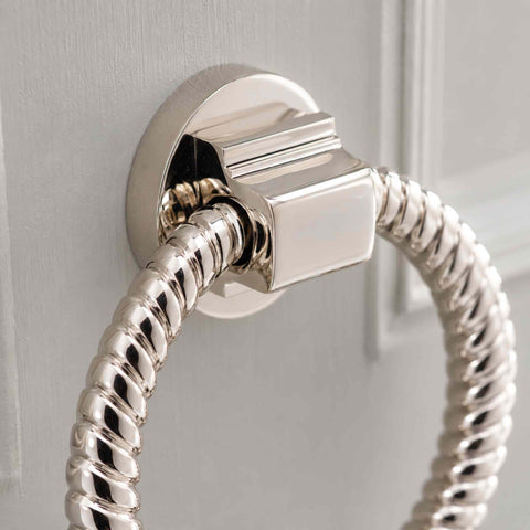 Detailed close-up of polished nickel reeded ring door knocker fixing plate and mounting block