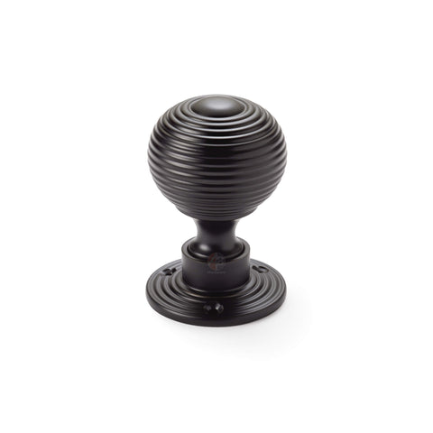 Single powder coated black reeded beehive rim mortice door knob on round rose backplate.