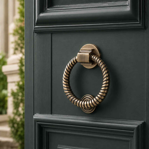 Antique Brass Reeded Ring Door Knocker installed on a traditional front door