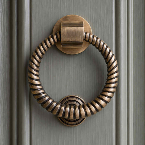 Front view of Antique Brass Reeded Ring Door Knocker mounted on a painted exterior door