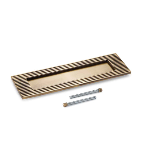 Reeded solid brass letter box plate in antique brass finish with fixing bolts included