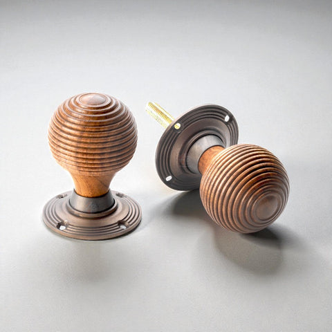 Rosewood matt antique beehive door knobs shown with spindle bar for installation