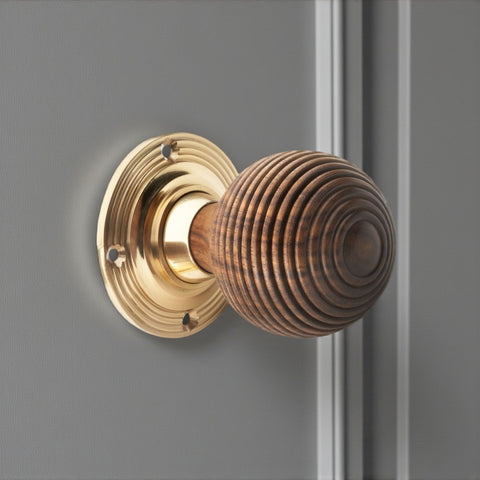 Rosewood polished brass beehive door knob installed on door