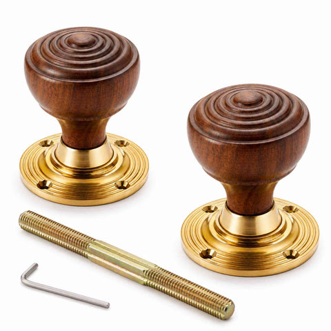 Pair of rosewood ringed mortice door knobs with unlacquered polished brass backplates, spindle and Allen key