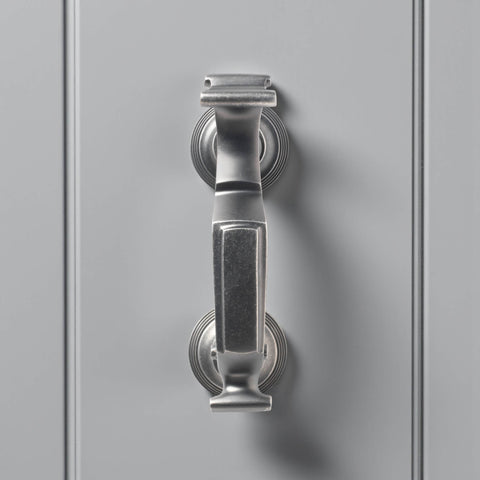 Front view of pewter reeded doctor door knocker on grey door, displaying traditional doctor style design and brushed metallic finish.