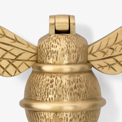 Close-up product image of satin brass bumble bee door knocker showing detailed textured finish
