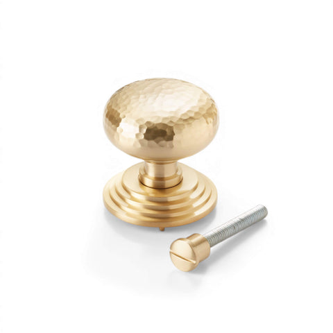 Satin brass hammered cottage centre door knob with stepped backplate and fixing bolt