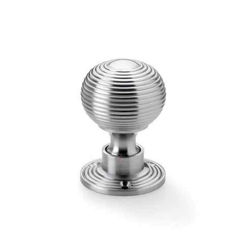 Single satin chrome reeded beehive rim mortice door knob on round rose backplate.