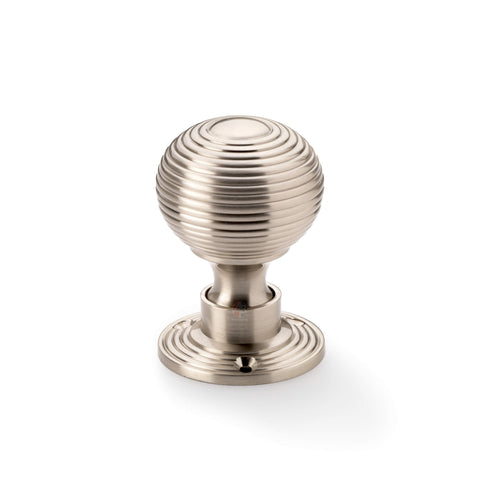 Single satin nickel reeded beehive rim mortice door knob on round rose backplate.