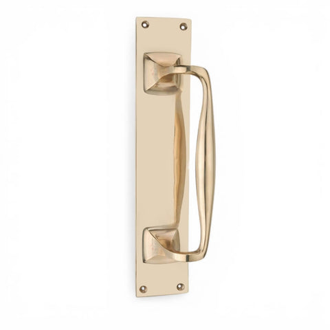 Solid brass door pull handle on rectangular backplate, polished finish, vertical position with four visible fixing holes.