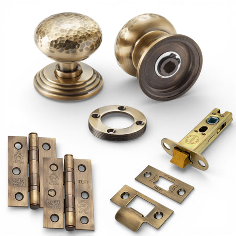 Solid brass hammered mortice door knobs on stepped backplate in antique brass latch pack with CE7 hinges and 3 inch tubular latch