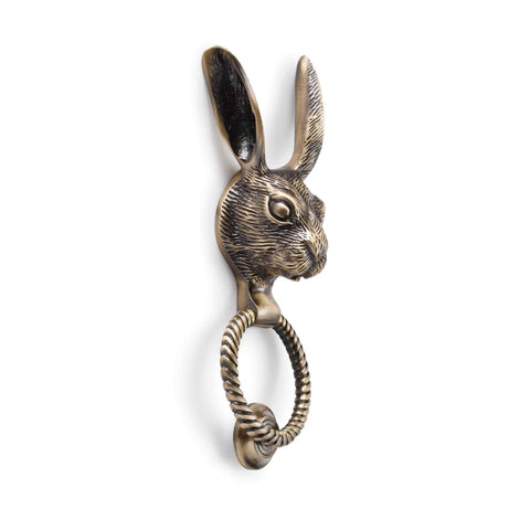 Solid brass hare door knocker with reeded ring in antique brass finish angled product view on a white background