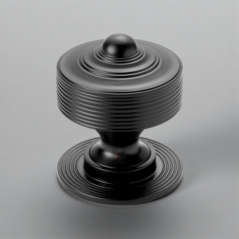 Solid brass reeded centre door knob in powder coated black finish displayed on a grey background.