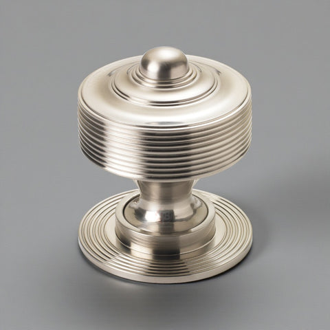 Solid brass reeded centre door knob in satin nickel finish shown against a grey background.