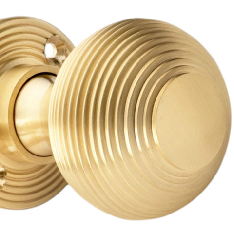Solid brass satin brass reeded beehive door knob close up