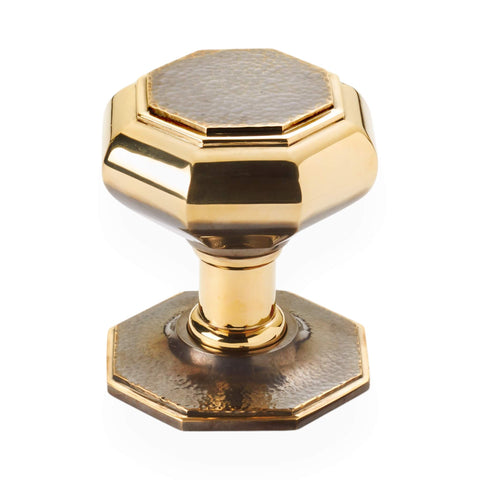 Very large aged brass hammered octagonal centre door knob front view with matching octagonal backplate