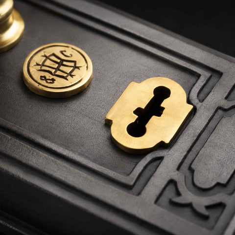 Macro detail of lock and brass escutcheon on Victorian pewter Davenport rim lock body