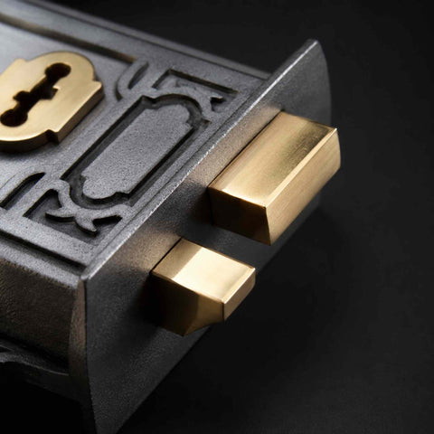 Close-up of solid brass lock bolt and latch mechanism on Victorian pewter cast iron Davenport rim lock