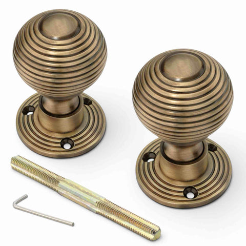 Pair of antique brass beehive rim mortice door knobs with matching backplates, threaded spindle and Allen key included.